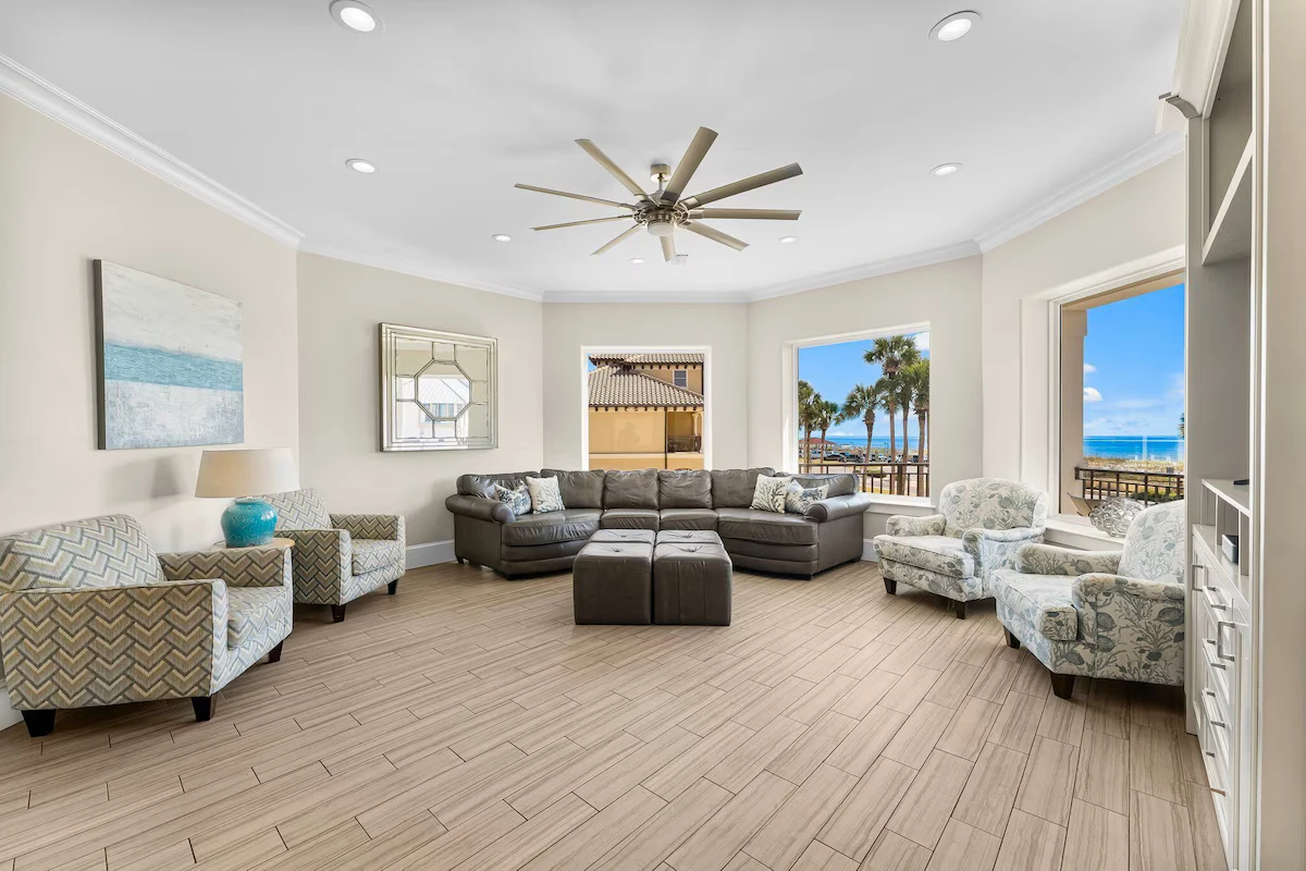 Bright living room with a sectional, armchairs and ocean-view windows